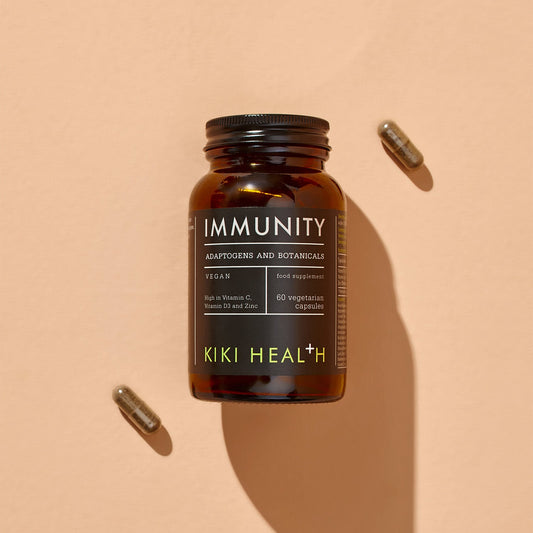 A brown bottle labelled Immunity with two capsules beside it.