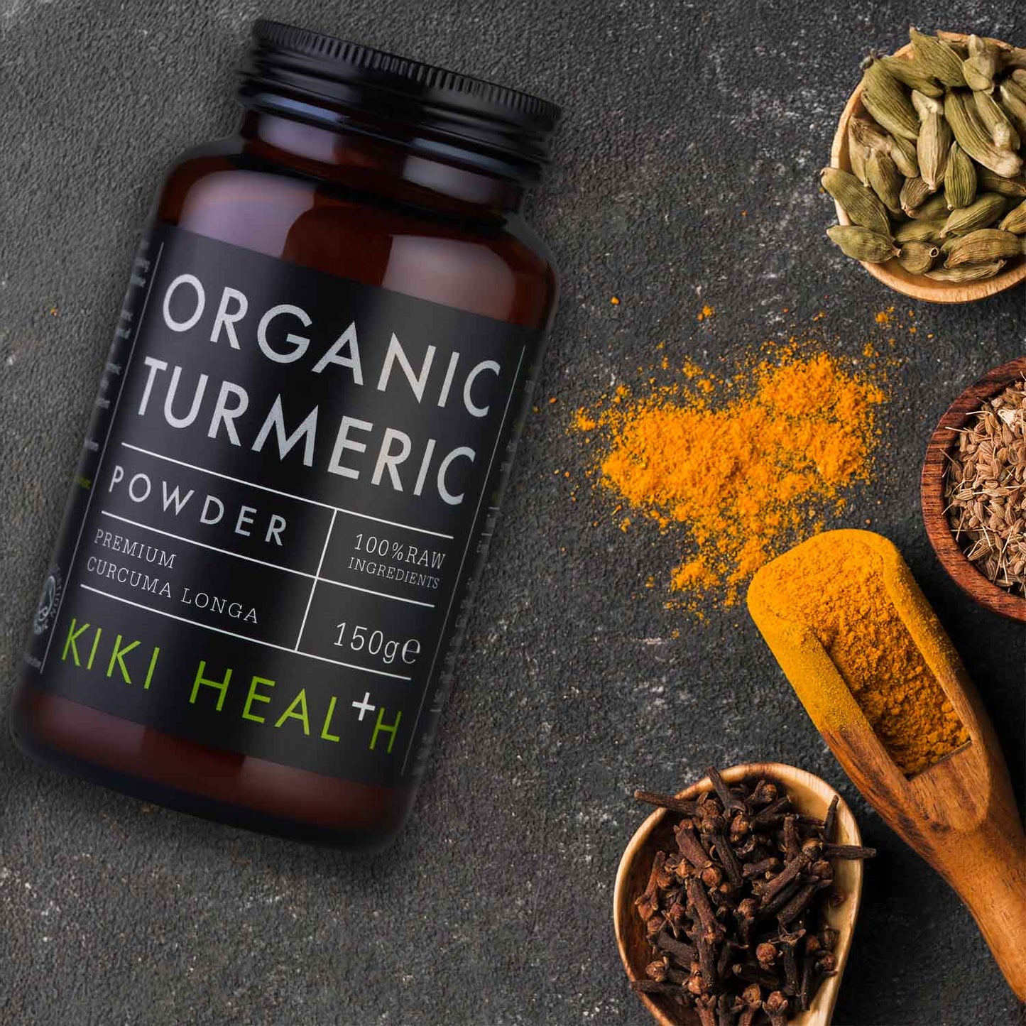 A bottle of organic turmeric with spices and a wooden spoon.