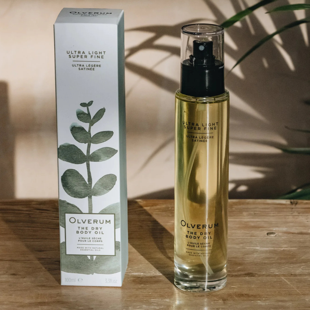 A box and bottle of cosmetic oil on a wooden surface.