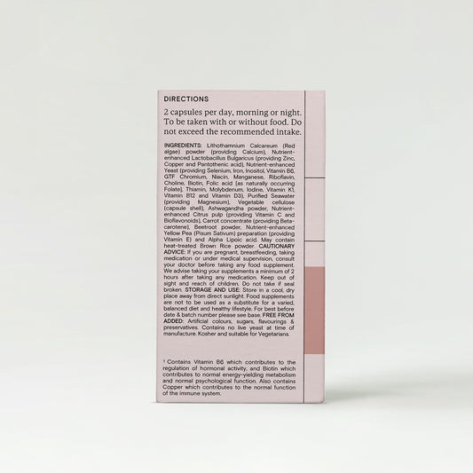 A close-up of a chocolate bar wrapper with text details and sections in pink and beige.