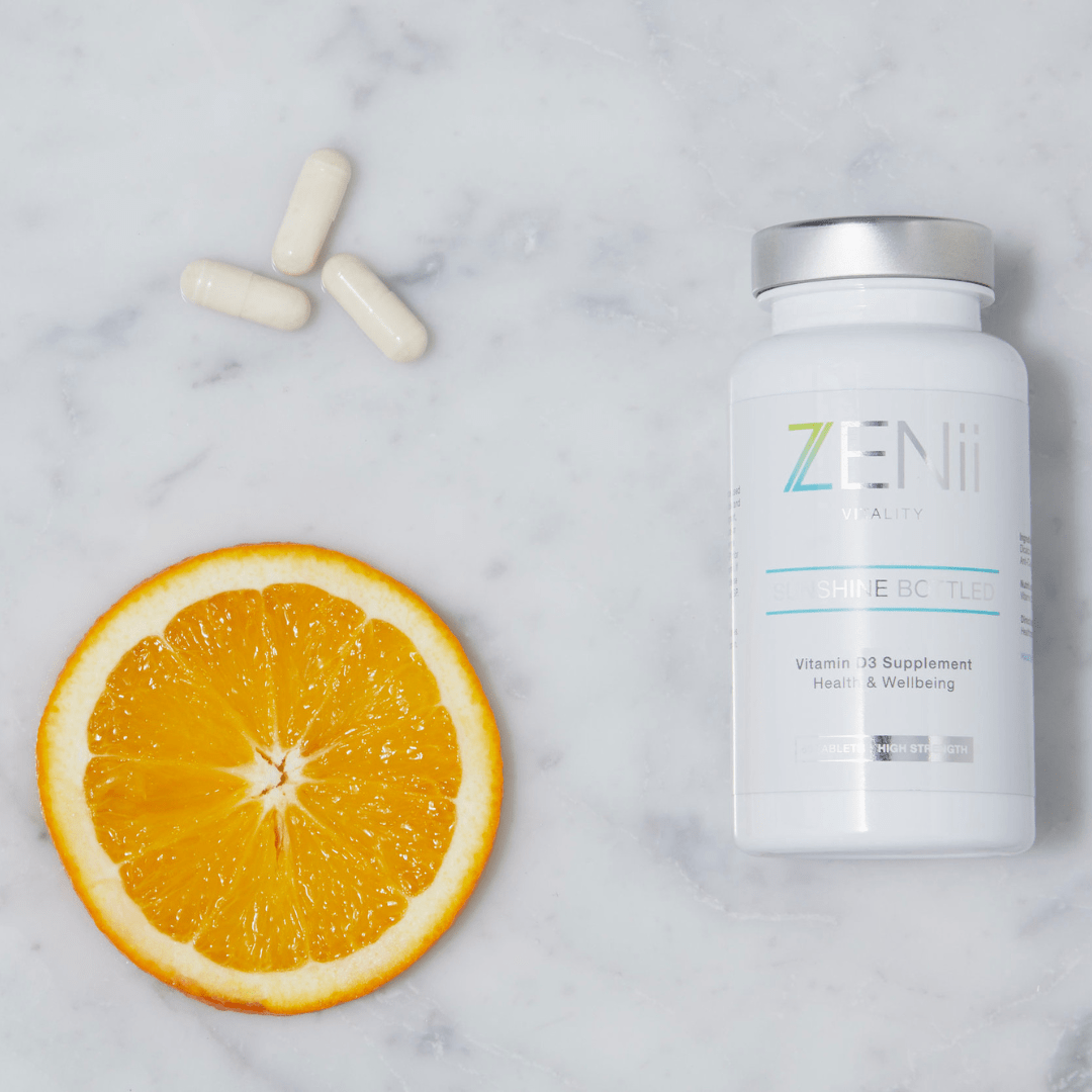 A bottle of Zen pills, a sliced orange, and three capsules.