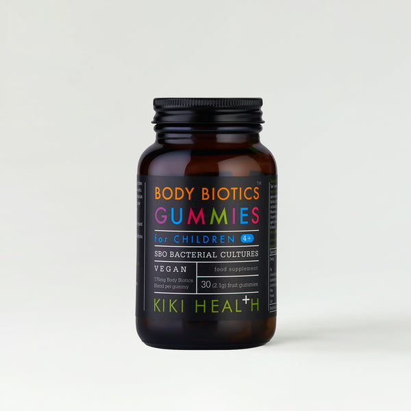 A dark jar labelled Body Biotics Gummies with colourful text.